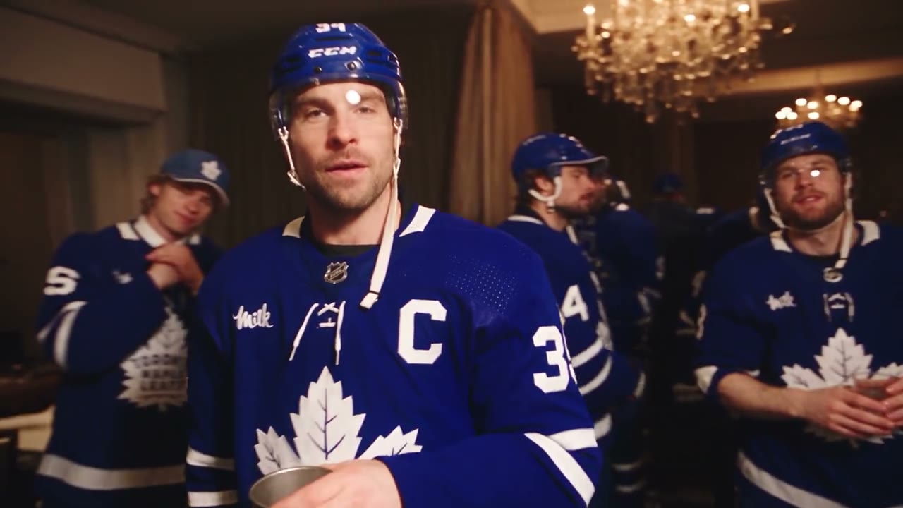 Burning Bridges AI community video with a lead and distinct supporting people in blue hockey jerseys